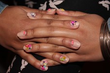 Manicure with nude polish with deco items. 