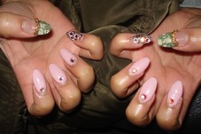 Dollar bill embedded nail art on thumbs with gold chain, and swarvoski crystals on rest of fingers. Acrylic full set.