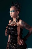 Creative photoshoot makeup with custom peacock feather eyelashes.