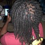 Additional hair added to natural hair style