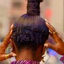 Fulani braids with individuals in the back